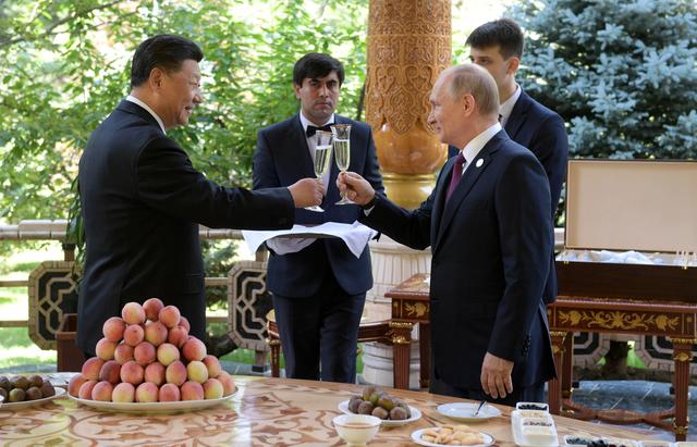 Russian President Vladimir Putin (R) toasts with Chinese President Xi Jinping while congratulating him on his birthday before the Conference on Interaction and Confidence-Building Measures in Asia (CICA) in Dushanbe, Tajikistan June 15, 2019. Sputnik/Alexei Druzhinin/Kremlin via REUTERS 