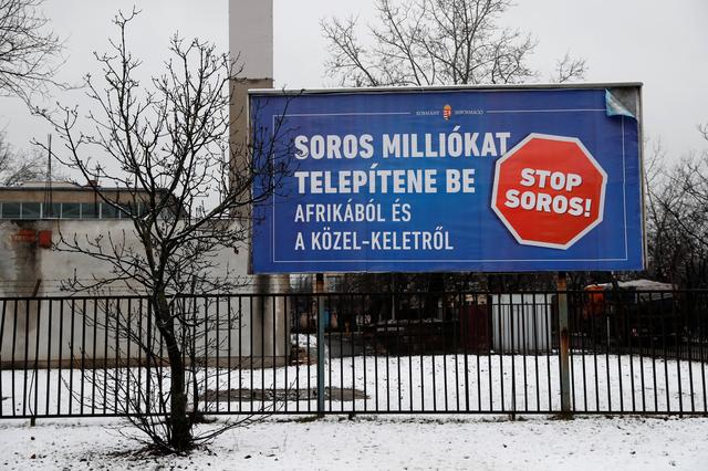 FILE PHOTO: A Hungarian government billboard that reads: 'Soros wants to transplant millions from Africa and the Middle East', is shown in Budapest, February 14, 2018. REUTERS/Bernadett  Szabo/File Photo