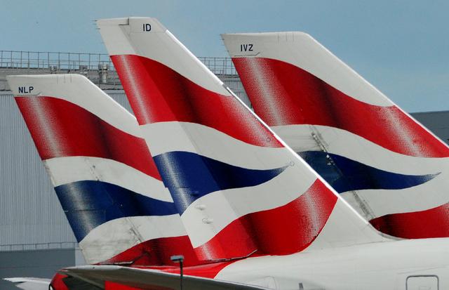 FILE PHOTO: British Airways logos are seen on tailfins at Heathrow Airport in west London, Britain May 12, 2011.  REUTERS/Toby Melville/Files