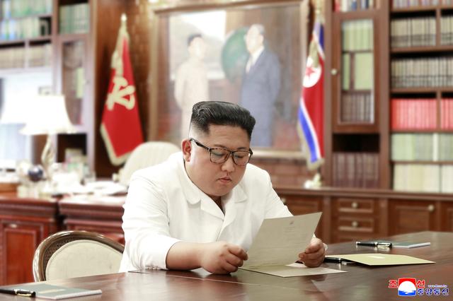 North Korean leader Kim Jong Un reads a letter from U.S. President Donald Trump, in Pyongyang, North Korea in this picture released by North Korea's Korean Central News Agency (KCNA) on June 22, 2019. KCNA via REUTERS  