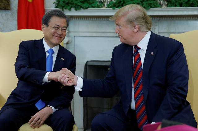 FILE PHOTO: South Korea’s President Moon Jae-in shakes hands with U.S. President Donald Trump at the start of a meeting in the Oval Office at the White House in Washington, U.S., April 11, 2019. REUTERS/Carlos Barria