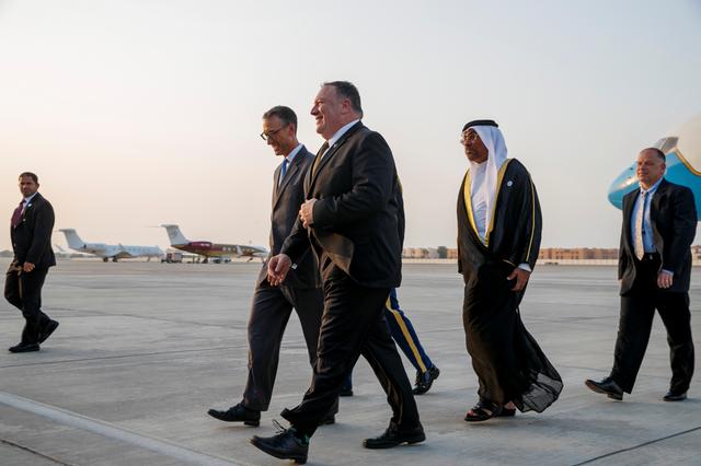 U.S. Secretary of State Mike Pompeo arrives in Abu Dhabi, next to U.S. Charge d'Affaires Steve Bondy and United Arab Emirates Minister of State Ahmed al-Sayegh, United Arab Emirates June 24, 2019. Jacquelyn Martin/Pool via REUTERS