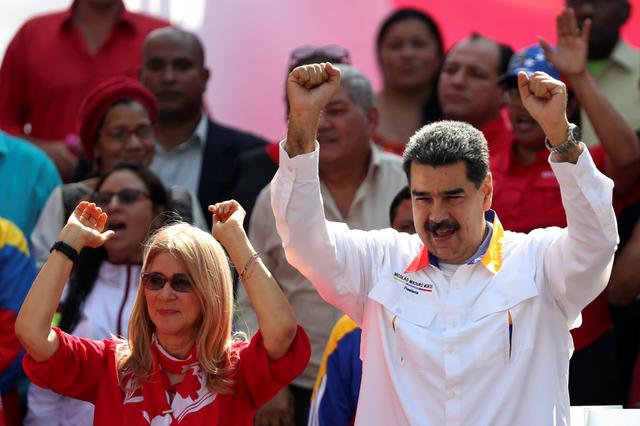 FILE PHOTO: Venezuela's President Nicolas Maduro and his wife Cilia Flores greet people during a rally in support of the government in Caracas, Venezuela May 20, 2019. REUTERS/Ivan Alvarado/File Photo