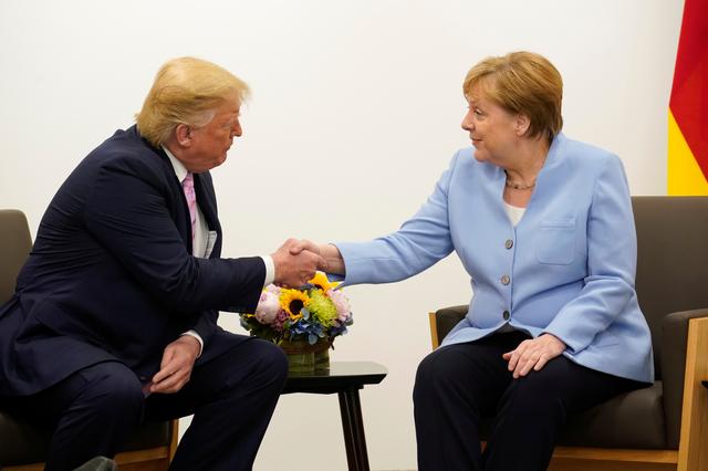 U.S. President Donald Trump shakes hands with Germany's Chancellor Angela Merkel during a bilateral meeting at the G20 leaders summit in Osaka, Japan, June 28, 2019.  REUTERS/Kevin Lamarque