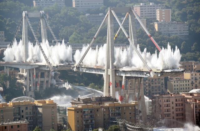 Controlled explosions demolish two of the pylons of the Morandi bridge almost one year since a section of the viaduct collapsed killing 43 people, in Genoa, Italy June 28, 2019. REUTERS/Massimo Pinca