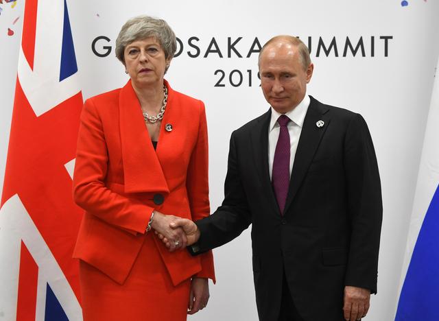 Russian President Vladimir Putin and British Prime Minister Theresa May shake hands during their meeting on the sidelines of the G-20 summit in Osaka, Japan June 28, 2019. Pool via REUTERS