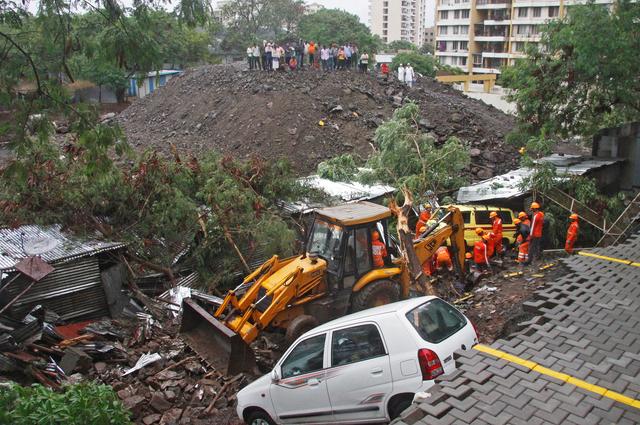 Rescue workers look for survivors among the debris of a collapsed wall of a residential complex in Pune, India, June 29, 2019. REUTERS/Stringer 