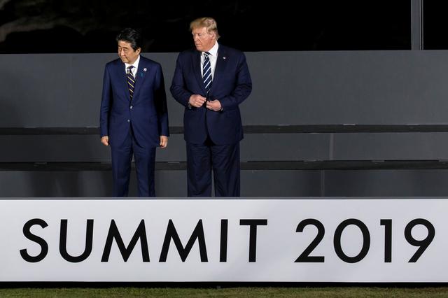 Japan's Prime Minister Shinzo Abe and U.S. President Donald Trump attend a family photo session in front of Osaka Castle at the G-20 summit, in Osaka, Japan June 28, 2019  Tomohiro Ohsumi/Pool via REUTERS