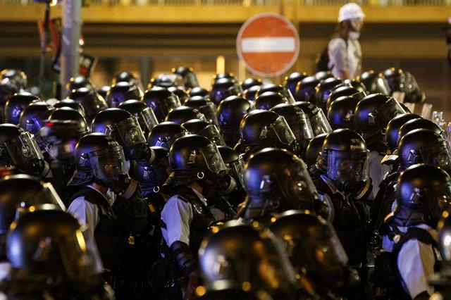 FILE PHOTO: Riot police clear the streets outside the Legislative Council building, after protesters stormed the building on the anniversary of Hong Kong's handover to China, in Hong Kong, China July 2, 2019. REUTERS/Thomas Peter/File Photo