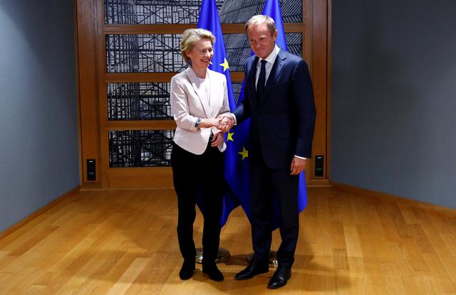 German Defense Minister Ursula von der Leyen, who has been nominated as European Commission President, shakes hands with EU Council President Donald Tusk in Brussels, Belgium, July 4, 2019. REUTERS/Francois Lenoir/Pool