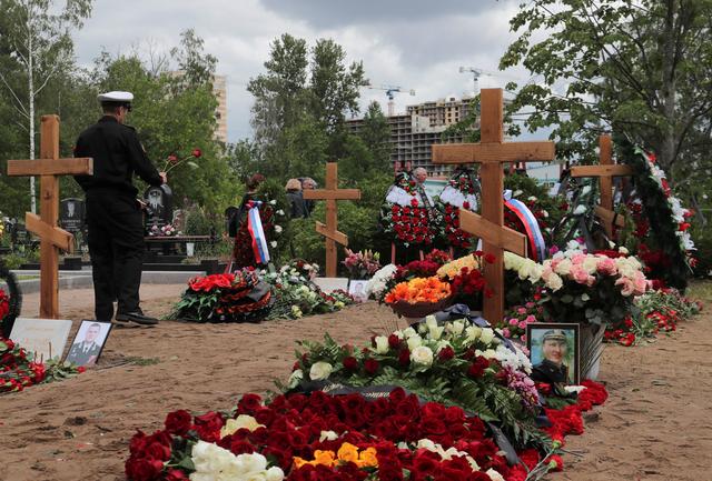 People attend the funeral of Russian sailors, who were recently killed in a fire on a secret nuclear research submarine in the area of the Barents Sea, at Serafimovskoye cemetery in Saint Petersburg, Russia July 6, 2019. REUTERS/Anton Vaganov
