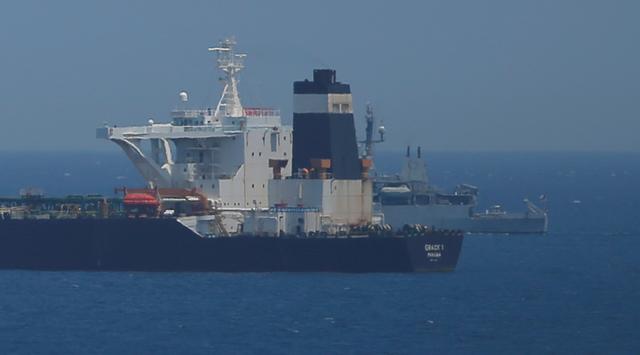FILE PHOTO: A British Royal Navy patrol vessel guards the oil supertanker Grace 1, suspected of carrying Iranian crude oil to Syria, as it sits anchored in waters of the British overseas territory of Gibraltar, July 4, 2019. REUTERS/Jon Nazca/File Photo