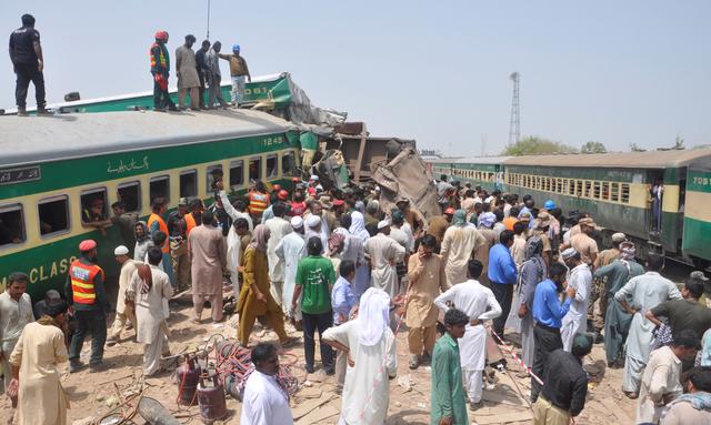Residents and rescue workers gather near the site after a passenger train collided with a cargo train in Sadiqabad, Pakistan July 11, 2019. REUTERS/Stringer