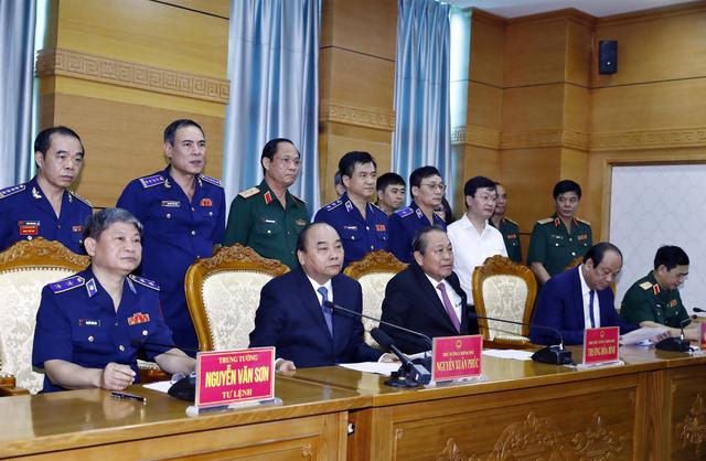 FILE PHOTO: Vietnam's Prime Minister Nguyen Xuan Phuc (2nd L, front) and Deputy Prime Minister Truong Hoa Binh (2nd R, front) speaks with sailors of Coast Guard Force on field via video call during their visit to Coast Guard Command in Hanoi, Vietnam July 11, 2019. Thong Nhat/VNA via REUTERS.