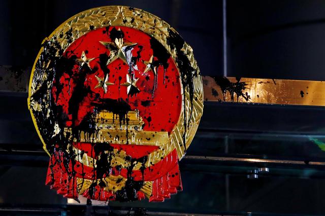 A National Emblem splashed with paint after anti-extradition bill protest is seen outside Chinese Liaison Office in Hong Kong, China July 21, 2019. REUTERS/Tyrone Siu