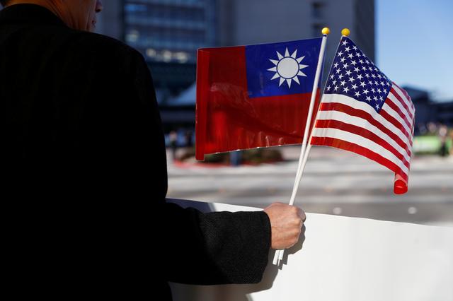 FILE PHOTO: A demonstrator holds flags of Taiwan and the United States in support of Taiwanese President Tsai Ing-wen during an stop-over after her visit to Latin America in Burlingame, California, U.S., January 14, 2017. REUTERS/Stephen Lam/File Photo