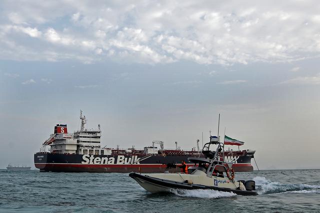 FILE PHOTO: A boat of Iranian Revolutionary Guard sails next to Stena Impero, a British-flagged vessel owned by Stena Bulk, at Bandar Abbas port, July 21, 2019. Iran, Mizan News Agency/WANA Handout via REUTERS/File Photo