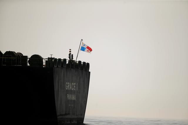 FILE PHOTO: A Panama flag flies on the stern of the Iranian oil tanker Grace 1 as it sits anchored after it was seized earlier this month by British Royal Marines off the coast of the British Mediterranean territory on suspicion of violating sanctions against Syria, in the Strait of Gibraltar, southern Spain July 20, 2019. REUTERS/Jon Nazca/File Photo