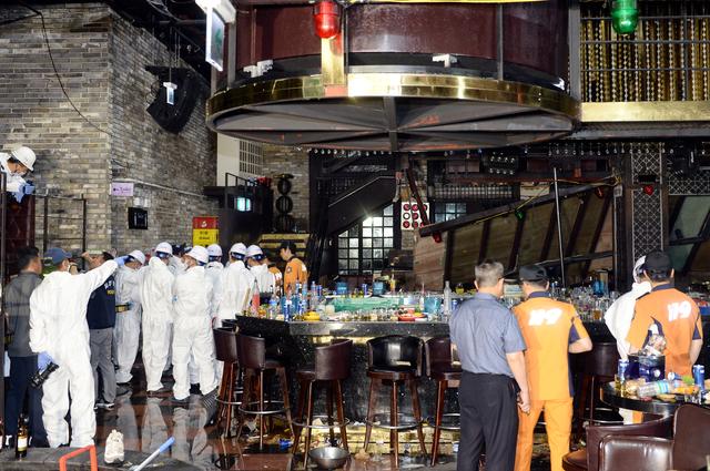 South Korean firefighters and officials examine the collapsed structure of a nightclub where several athletes competing at the World Aquatics Championships were dancing, in Gwangju, South Korea, July 27, 2019.  Yonhap via REUTERS  