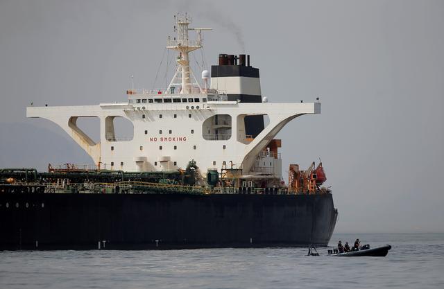FILE PHOTO: Gibraltar defence police officers guard the Iranian oil tanker Grace 1 as it sits anchored after it was seized earlier this month by British Royal Marines off the coast of the British Mediterranean territory on suspicion of violating sanctions against Syria, in the Strait of Gibraltar, southern Spain July 20, 2019. REUTERS/Jon Nazca