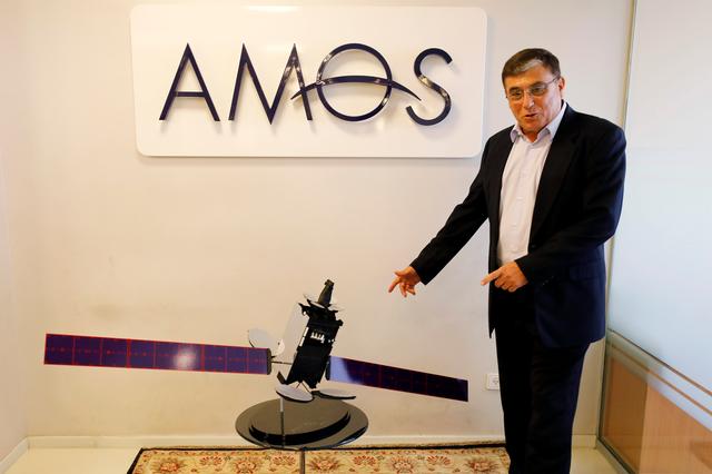 David Pollack, CEO of Israel's Space Communication Ltd gestures next to a model of Amos-17 satellite at the company offices in Ramat Gan, Israel July 28, 2019. REUTERS/Amir Cohen