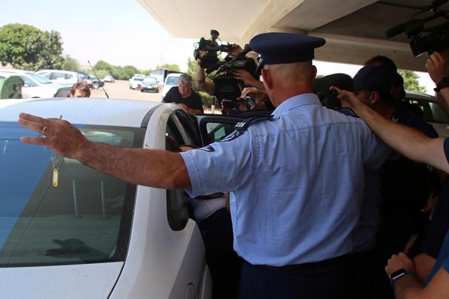 A British tourist is escorted into a police car outside the Famagusta courthouse in Paralimni, Cyprus July 29, 2019. REUTERS/Yiannis Kourtoglout