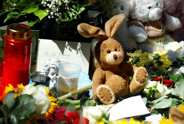 Messages of mourning, candles, flowers and plush toys are placed by people for an eight-year-old boy who was pushed by a man in front of an oncoming train and died at the main train station in Frankfurt, Germany, July 30, 2019. REUTERS/Ralph Orlowski