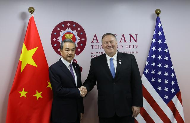 U.S. Secretary of State Mike Pompeo shakes hands with Chinese Foreign Minister Wang Yi on the sidelines of the ASEAN Foreign Ministers' Meeting in Bangkok, Thailand, August 1, 2019. REUTERS/Jonathan Ernst/Pool
