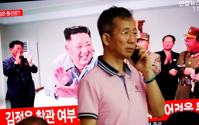 A man stands near a TV showing a file picture of North Korean leader Kim Jong Un for a news report on North Korea firing short-range ballistic missiles, in Seoul, South Korea, July 31, 2019.    REUTERS/Kim Hong-Ji
