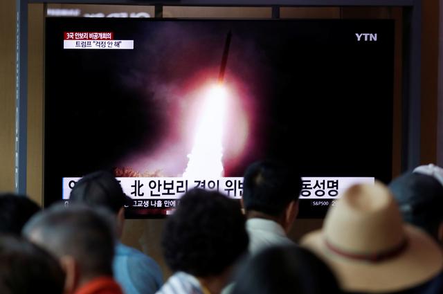 People watch a TV showing a file picture of a North Korean missile for a news report on North Korea firing short-range ballistic missiles, in Seoul, South Korea, August 2, 2019.    REUTERS/Kim Hong-Ji