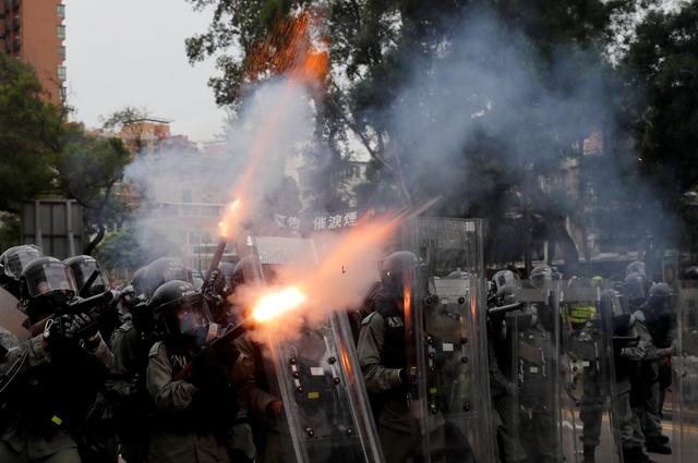 FILE PHOTO: Police officers fire tear gas at demonstrators during a protest against the Yuen Long attacks in Yuen Long, New Territories, Hong Kong, China July 27, 2019. REUTERS/Tyrone Siu