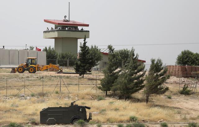 FILE PHOTO: Turkish soldiers stand on a watch tower at the Atmeh crossing on the Syrian-Turkish border, as seen from the Syrian side, in Idlib governorate, Syria May 31, 2019. REUTERS/Khalil Ashawi