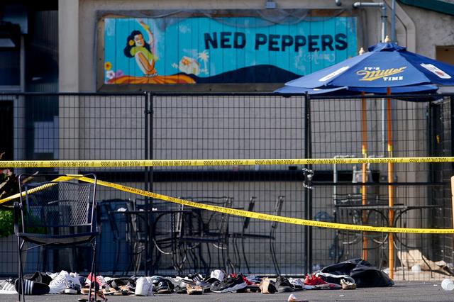 Shoes are piled in the rear of Ned Peppers Bar at the scene after a mass shooting in Dayton, Ohio, U.S. August 4, 2019.  REUTERS/Bryan Woolston