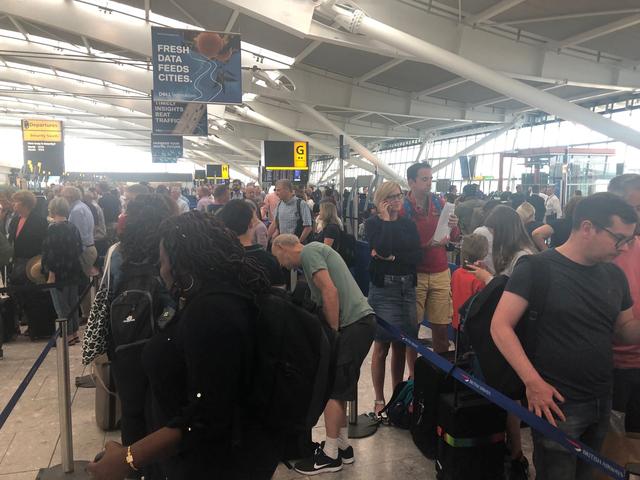 Passengers wait in long queues at Heathrow Airport as IT problems caused flight delays in London, Britain, August 7, 2019 in this picture obtained from social media. Paul Trickett via REUTERS