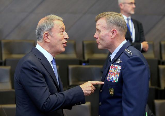 FILE PHOTO: Turkish Defence Minister Hulusi Akar (L) and the Supreme Allied Commander Europe, U.S. Air Force General Tod Wolters, speak at a NATO meeting in Brussels, Belgium, June 26, 2019. REUTERS/Francois Walschaerts/File Photo