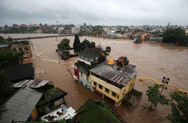 FILE PHOTO: Houses are seen submerged in the waters of overflowing river Godavari after heavy rainfall in Nashik, India, August 5, 2019. REUTERS/Francis Mascarenhas