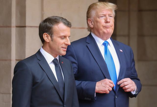 FILE PHOTO: French President Emmanuel Macron speaks with U.S. President Donald Trump ahead of a meeting at the Prefecture of Caen, on the sidelines of D-Day commemorations marking the 75th anniversary of the World War II Allied landings in Normandy, France,  June 6, 2019. Ludovic Marin/Pool via REUTERS/File Photo
