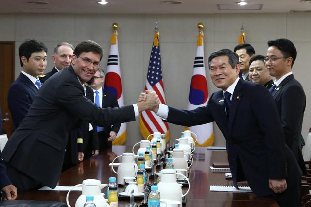 U.S. Defense Secretary Mark Esper clasps hands with South Korean Defense Minister Jeong Kyeong-doo during their meeting in Seoul, South Korea, August 9, 2019. Chung Sung-Jun/Pool via REUTERS