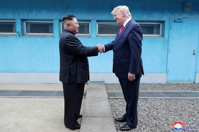 FILE PHOTO: U.S. President Donald Trump shakes hands with North Korean leader Kim Jong Un as they meet at the demilitarized zone separating the two Koreas, in Panmunjom, South Korea, June 30, 2019. KCNA via REUTERS  