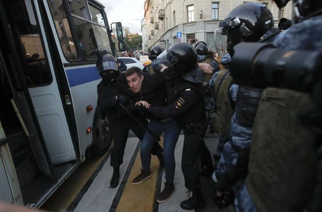 Law enforcement officers detain a man after a rally to demand authorities allow opposition candidates to run in the upcoming local election in Moscow, Russia August 10, 2019. REUTERS/Maxim Shemetov