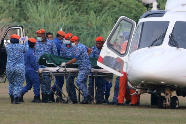 A body believed to be 15-year-old Irish girl Nora Anne Quoirin who went missing is brought out of a helicopter in Seremban, Malaysia, August 13, 2019. REUTERS/Lim Huey Teng