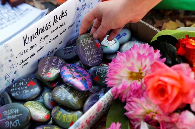 FILE PHOTO - Pebbles with messages are seen at a memorial site for victims of Friday's shooting, in front of Christchurch Botanic Gardens in Christchurch, New Zealand March 19, 2019. REUTERS/Jorge Silva