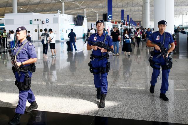 Armed police patrol the departure hall of the airport in Hong Kong after clashes with protesters, China August 14, 2019.  REUTERS/Thomas Peter