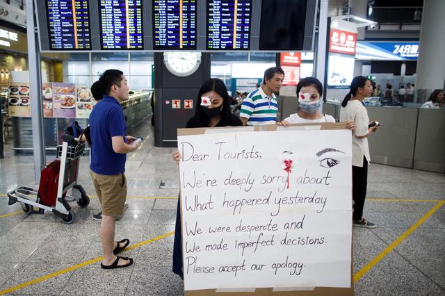 Anti-government demonstrators apologize for yesterday's clashes with police at the airport in Hong Kong China August 14, 2019.  REUTERS/Thomas Peter