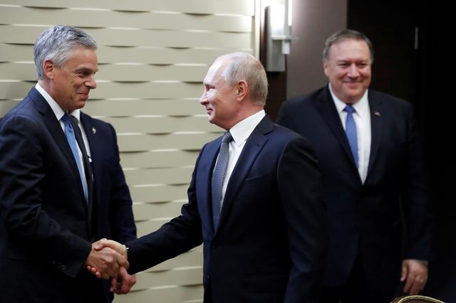 FILE PHOTO: Russian President Vladimir Putin shakes hands with U.S. Ambassador to Russia Jon Huntsman, left, as U.S. Secretary of State Mike Pompeo stands behind prior to their talks in the Black Sea resort city of Sochi, Russia, May 14, 2019. Pavel Golovkin/Pool via REUTERS/File Photo