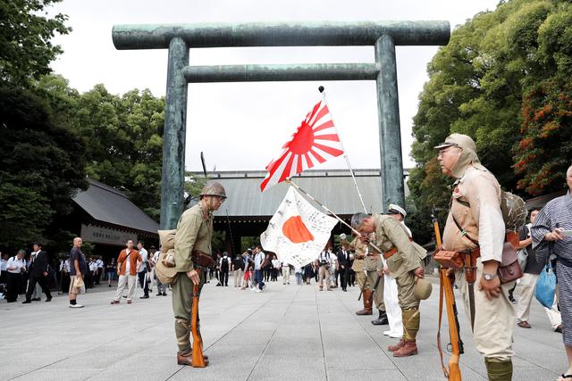 Men wearing Japanese imperial military uniform visit the Yasukuni Shrine in Tokyo, Japan August 15, 2019, on the 74th anniversary of Japan's surrender in World War Two. REUTERS/Kim Kyung-Hoon