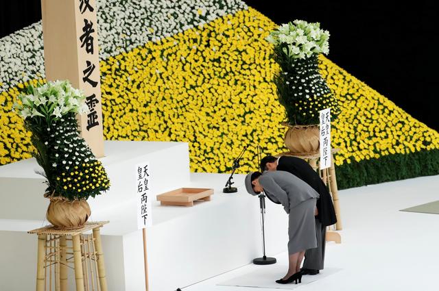 Japan's Emperor Naruhito and Empress Masako bow during a memorial service ceremony marking the 74th anniversary of Japan's surrender in World War Two, in Tokyo, Japan August 15, 2019. REUTERS/Kim Kyung-Hoon