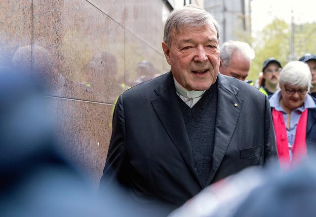 FILE PHOTO: Vatican Treasurer Cardinal George Pell is surrounded by Australian police as he leaves the Melbourne Magistrates Court in Australia, October 6, 2017.    REUTERS/Mark Dadswell