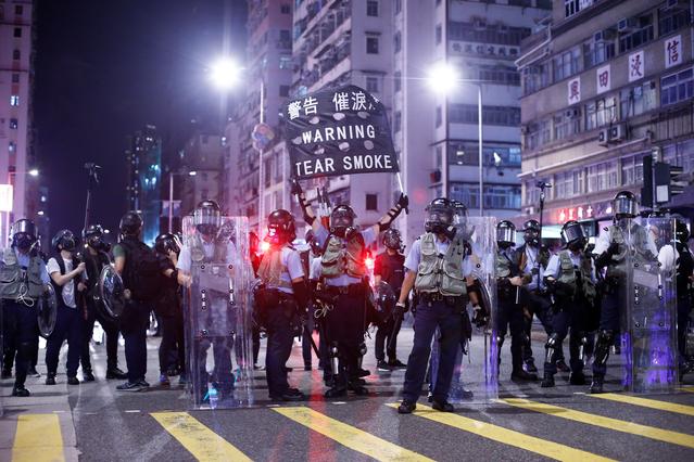 Police stand at a junction in the Sham Shui Po neighbourhood during clashes with anti-extradition bill protesters in Hong Kong, China, August 14, 2019.  REUTERS/Thomas Peter