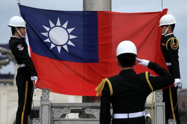 FILE PHOTO: Military honour guards attend a flag-raising ceremony at Chiang Kai-shek Memorial Hall, in Taipei, Taiwan March 16, 2018. REUTERS/Tyrone Siu/File Photo